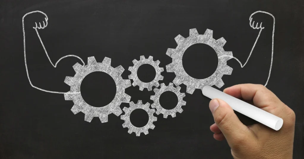 chris spurling mindset symbolized by gears forming strength and resilience on a chalkboard