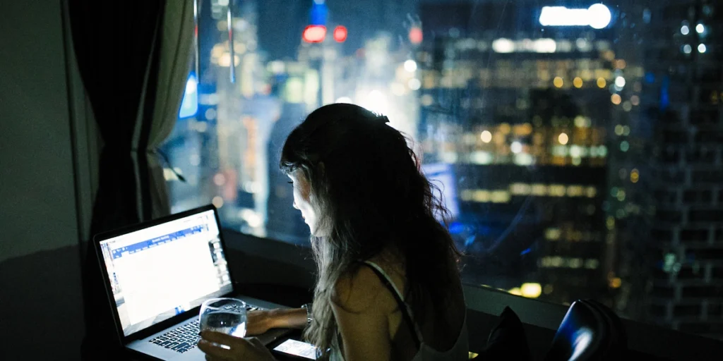 Chris Spurling entrepreneurship mindset symbolized by an entrepreneur working late on a laptop with coffee.